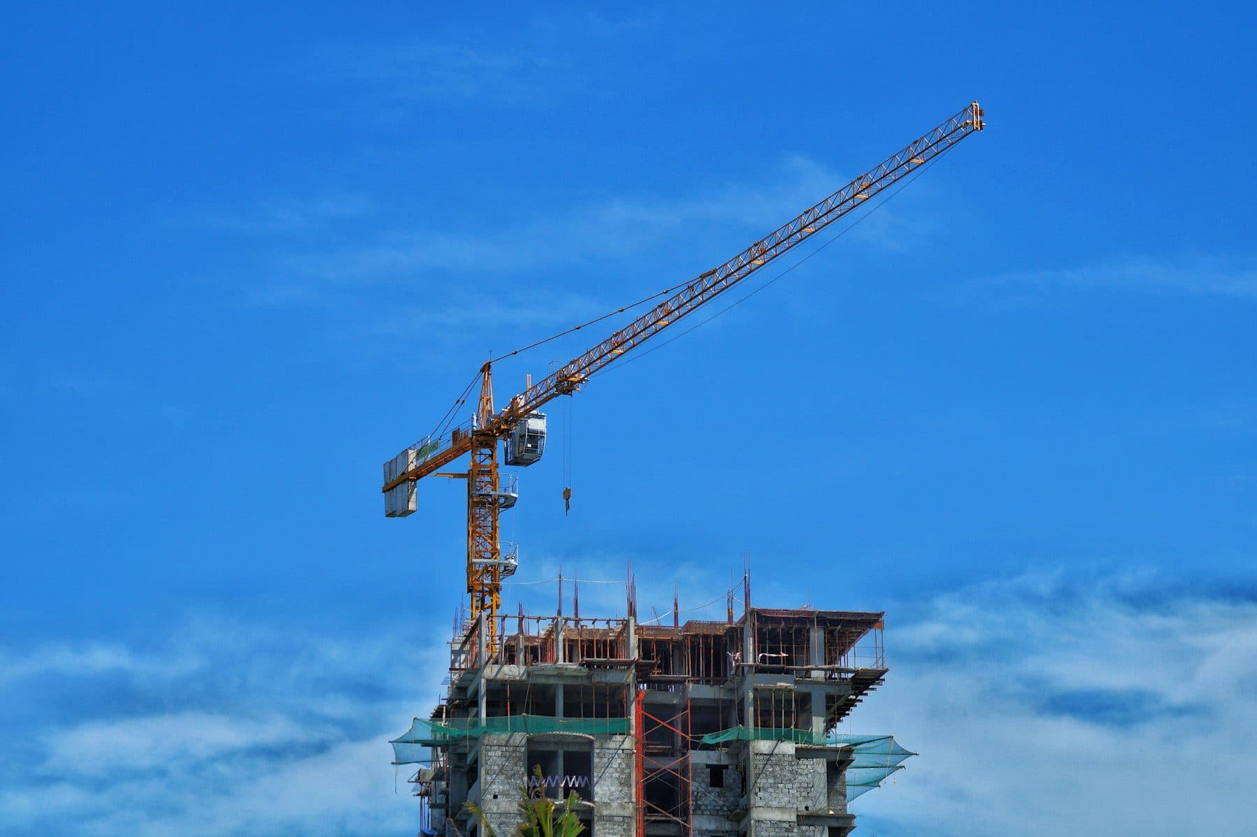 Tower cranes above a construction site at dusk