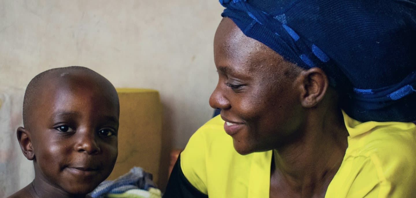 A mother looks at her young child, who is smiling. Maternity, neonatal and children's care, for mothers, newborn babies and children, are planned services at TEMCO, opening 2029.